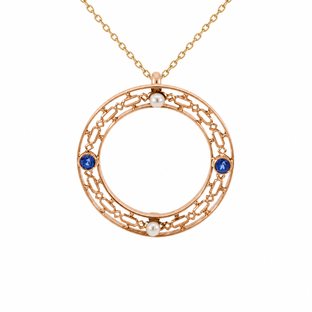 Vintage 10K yellow gold Ceylon blue sapphire and pearl pendant featuring a 0.12CT blue sapphire accented by a lustrous pearl.