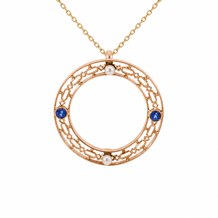 Vintage 10K yellow gold Ceylon blue sapphire and pearl pendant featuring a 0.12CT blue sapphire accented by a lustrous pearl.