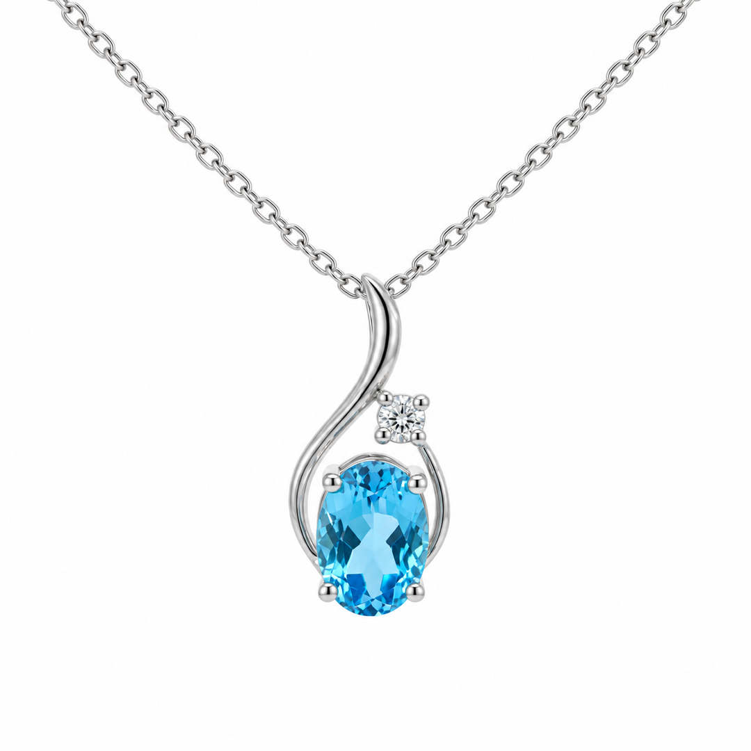 14K white gold blue topaz and diamond swirl pendant featuring a 0.83CT natural oval blue topaz accented by round diamonds.
