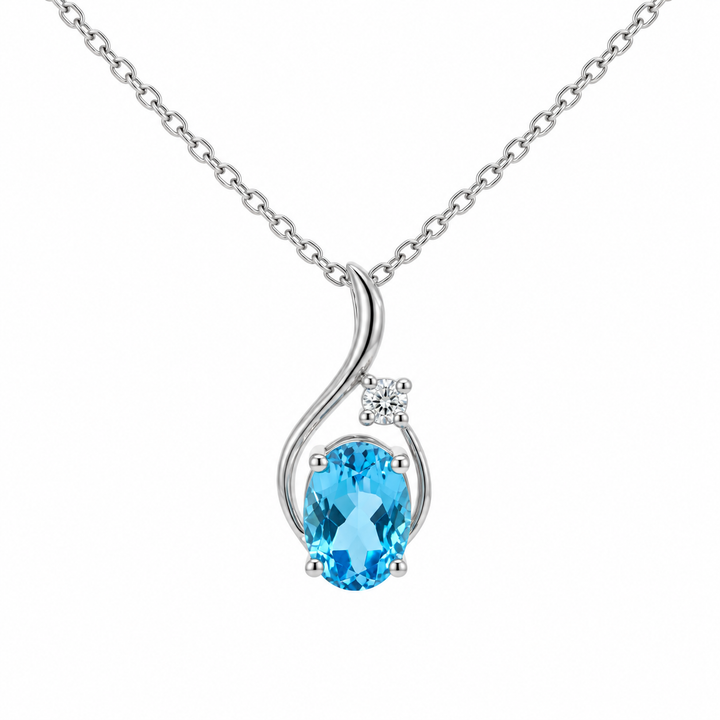 14K white gold blue topaz and diamond swirl pendant featuring a 0.83CT natural oval blue topaz accented by round diamonds.