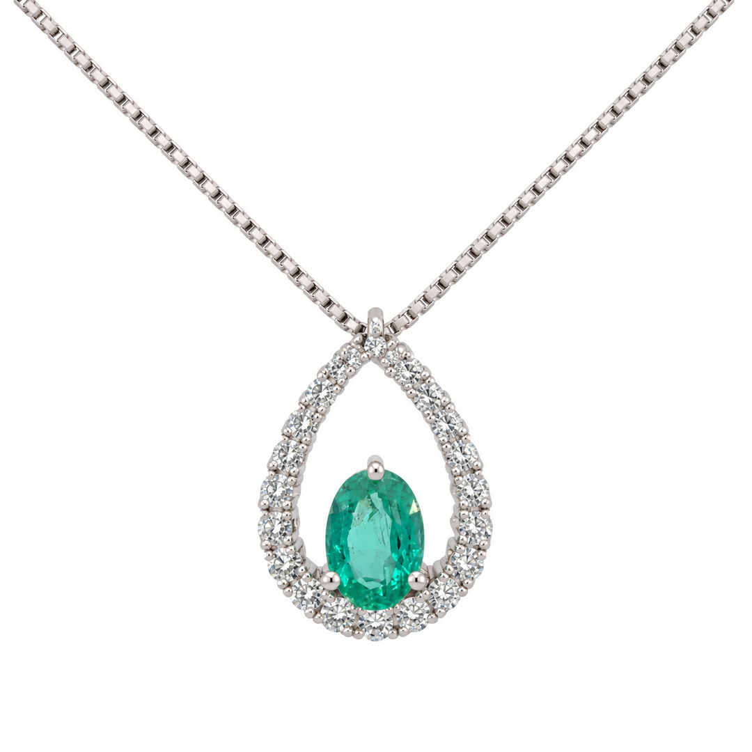 14K white gold emerald and diamond halo pendant featuring a 0.60CT emerald surrounded by sparkling diamond accents.