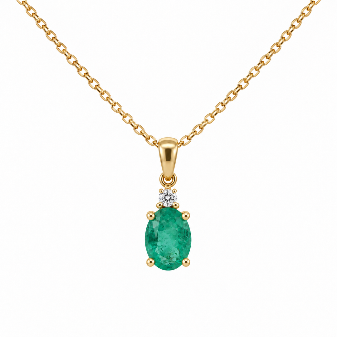 14K yellow gold natural oval emerald and diamond pendant featuring 0.71CTW gemstones with sparkling diamond accents.