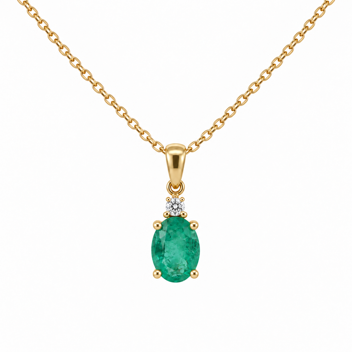14K yellow gold natural oval emerald and diamond pendant featuring 0.71CTW gemstones with sparkling diamond accents.