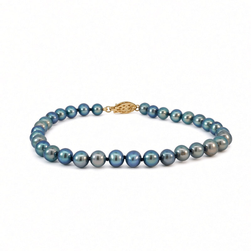 A single-strand pearl necklace featuring iridescent blue-gray pearls with a gold clasp