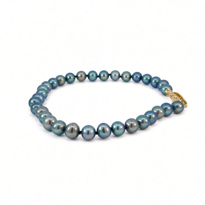 A strand of round Tahitian blue-gray pearls with a gold clasp