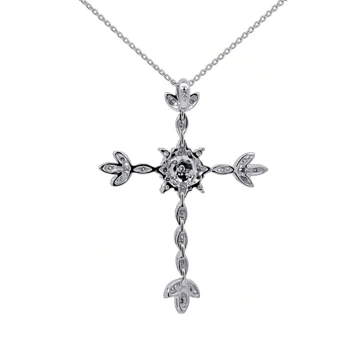A silver cross pendant necklace with a central clear gemstone and small clear stones along the arms and dangle