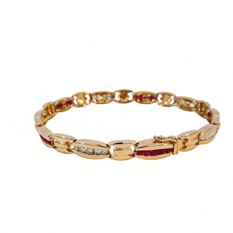 A yellow gold tennis bracelet featuring oval links set with small round diamonds and rows of round-cut red gemstones