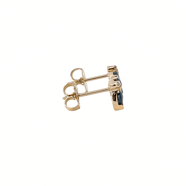 A pair of gold post earrings set with dark blue stones
